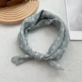 Detail van grijsblauwe zijden sjaal met bloemenprint en zachte geknoopte textuur - Groen