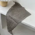 Detail of vintage striped linen scarf with brown and beige patterns in a minimalist setting - Horizontal Stripes