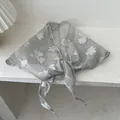 Detail of gray floral triangle scarf showing white ginkgo leaf patterns and sheer texture - 28*115cm / Gray