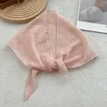 Detailed close-up of light pink lace triangular scarf with elegant floral patterns - Watermelon red