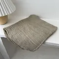 Close-up of light khaki pleated scarf with soft texture draped on a white shelf - 180x90cm / Khaki