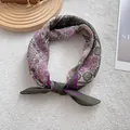 Vintage paisley print bandana in purple and green, styled as an elegant headscarf - Green