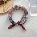 Detail shot of vintage cotton linen scarf with bohemian paisley and floral pattern texture - Red Edge