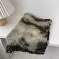Detail view of tie-dye wool scarf with frayed edges on a textured white surface - 180x90cm / Dark Green