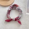 Detail view of retro bohemian silk square scarf with geometric and floral pattern knot - Raspberry Pink