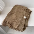 Macro shot of brown pleated cotton scarf fabric with fringed edges and quality label - 180*90CM / Ginger Yellow