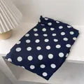 Detailed texture of navy blue scarf with large white polka dots next to a pleated lamp - 180*60cm / Navy Blue