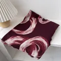 Detail of burgundy scarf with abstract pink swirl pattern and delicate fringe edges - 180x60cm / Red