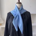 Light blue wool knit triangle scarf shown on a mannequin with a black blazer jacket - 100*30cm / Sky Blue