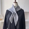 Detail of grey 50% wool knitted triangle scarf draped over a black blazer jacket - 100*30cm / Gray