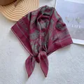 Detail of burgundy square scarf with green paisley patterns and silky fabric texture - Paisley Print / Red