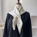 Detail of cream wool blend knitted triangle scarf featuring a silver metal accent button - 100*30cm / Cream Rice