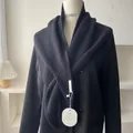 Minimalist black knit shawl wrap with vertical stripe texture on a stylish blazer - Black