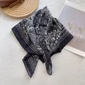 Detailed view of vintage black and white ethnic floral print on lightweight square scarf - Black