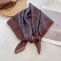 Detail of the vintage mandala print on brown square scarf with neat rolled hem edges - Coffee