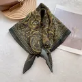 Detail of vintage floral print cotton square scarf on white rug with a brown bag - Yellow