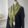 Detail of green knitted scarf with ribbed texture on a black suit jacket for women - Mustard Green