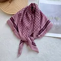 Detail of rose pink silk scarf showing geometric diamond pattern and rolled hem finish - Pink