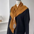 Detailed ribbed knit texture of mustard yellow shawl on a double-breasted coat - Sunset Orange