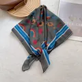 Detail of silk-like square scarf with sunflower prints and blue striped edges - Fruit Orchard Green