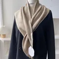 Close-up of beige ribbed knit shawl material texture on a black blazer with brand labels - Milk Tea