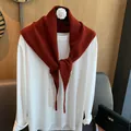 Burnt orange wool blend knit shawl scarf draped over a white long-sleeve basic shirt - Red