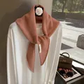 Detail view of pink wool knit scarf showing intricate waffle texture and MUCO brand label - Pink
