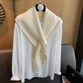 Minimalist knit shawl over white long sleeve top showing thick rib texture on a hanger - Off White