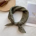 Detail of dark green floral silk scarf tied as a necktie on a stylish wooden tray - 70x70cm / Green Grille