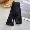 Detail of black knitted scarf with handmade floral accent on soft white background - 3D Rose Flower Style / Black