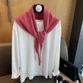 Detail of pink knitted wool shawl with button closure on white crew neck long sleeve shirt - Pink