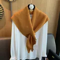 Detailed knit texture of ginger yellow triangular shawl with thick ribbed weaving pattern - Orange