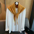 Detail of mustard yellow knit shawl with metal buckle over white long sleeve tee - Ginger Yellow