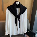 Detail des Strickschals mit Silberknopf auf weißem Langarmshirt für Damen - Schwarz