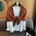 Caramel knitted paisley shawl layered over a white long sleeve tee for a vintage look - Bright Orange