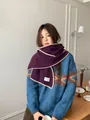 Detail of chunky knit wool scarf featuring deep purple texture and cream contrast hem - Purple