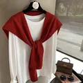 Detail of wool knit shawl draped over a white tee with premium ribbed texture finish - Red