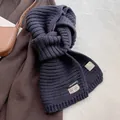 Detail of blue wool blend knit scarf with stitched brand label and fabric composition - Photogenic Navy Blue