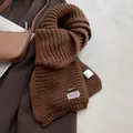 Detailed macro view of the thick knit texture and brown wool blend scarf with labels - Khaki Brown