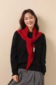 Detail of red 100% wool knit scarf with hollow fishbone pattern and fabric label - Christmas Red