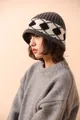 Detailed close-up of a grey 100% wool knit hat featuring a black and white geometric pattern - Gray