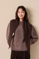 Detail of 100% wool scarf showing the authentic fabric label and premium knit texture - Cocoa Brown