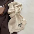 Cream knit wool blend scarf with thick texture shown against brown coat styling - Beige Apricot