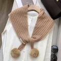 Detail of wool cashmere triangle scarf showing camel knit texture and pompom accents - Khaki