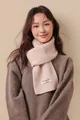 Detailed close-up of cream knit wool scarf with premium texture and woven label - Off White