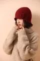 Close-up of deep red knit beanie with handmade 3D floral accent and thick weave texture - Red