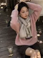 Detail view of pink fluffy sweater paired with grey contrast wool scarf for winter - Dark Gray and Khaki Edge