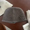 Detail of handmade crochet knit beanie featuring a 3D flower and ribbed texture - Khaki