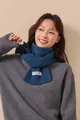 Detail of navy blue ribbed knit wool scarf with premium woven brand label texture - Blue