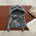Close-up of grey wool blend knit balaclava with buttons and decorative brand label - Grey Blue